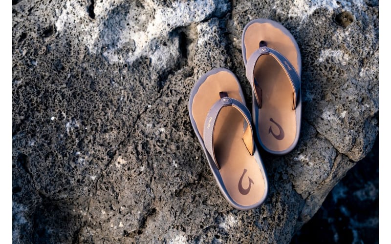 Traditional Handmade Fishing Trap and Flip Flops on Sand Stock