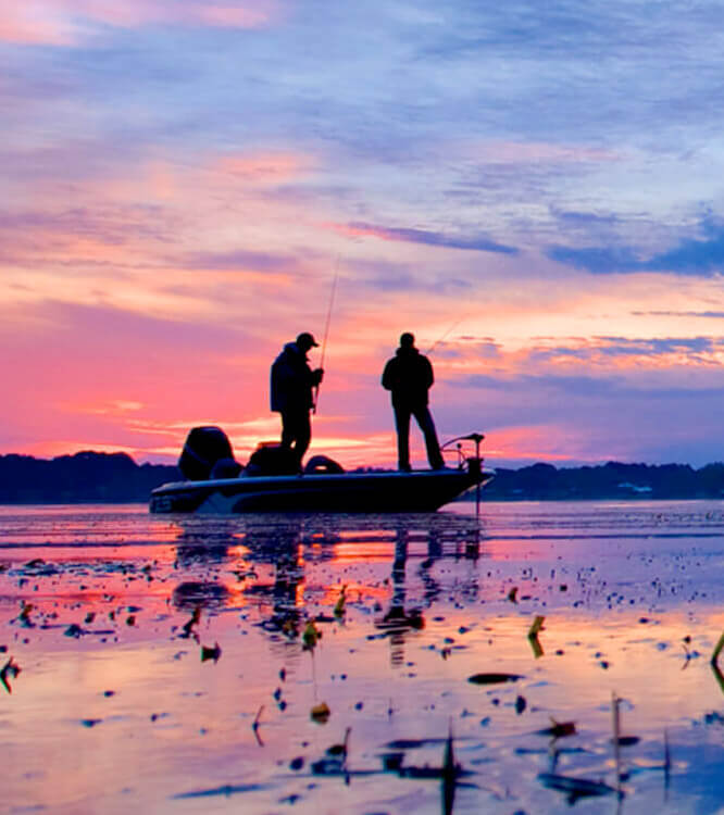 two people fishing off boat