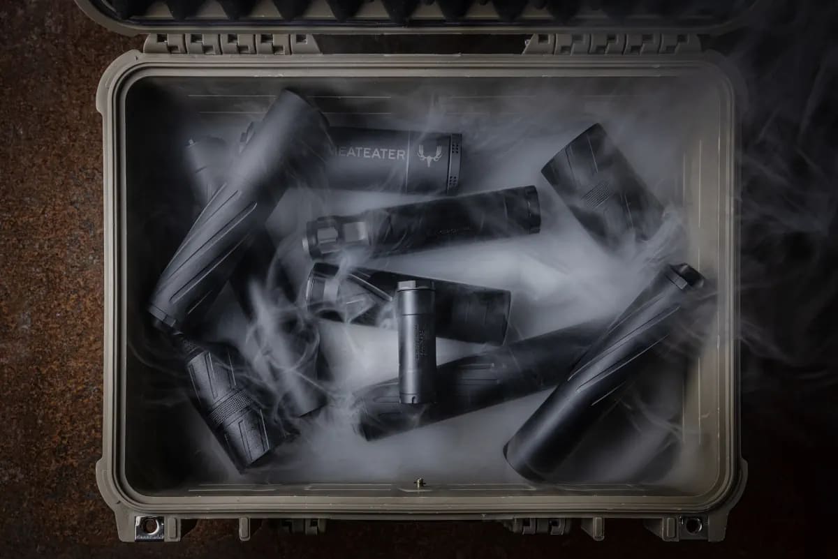 Suppressors covered in smoke in a box