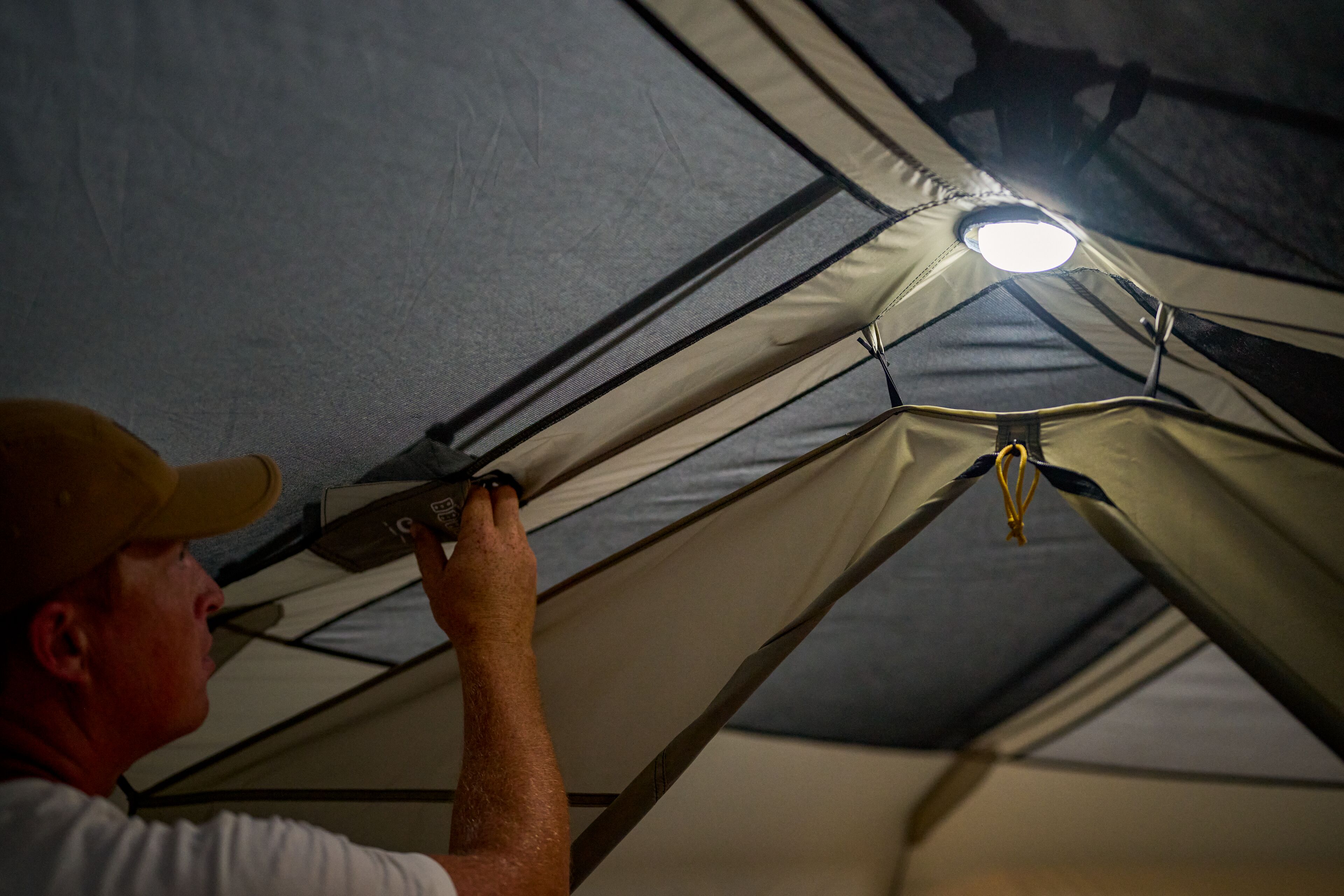 Interior view of an Ascend Lighted Instant Cabin Tent showing the built-in LED light hub illuminating the space.