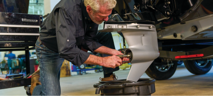A technician services an engine