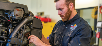 A technician repairs a boat's cosmetic issue